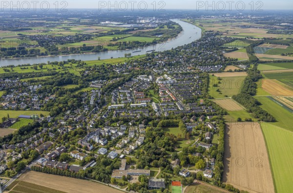 Aerial view, residential area district Wittlaer at the river Rhine, surrounded by meadows and fields, housing estate and three-winged house, former children's home at Bergesweg, Wittlaer, Düsseldorf, Ruhr area, North Rhine-Westphalia, Germany, DE, Europe, property tax, real estate, aerial view, aerial photography, aerial photography, overview, bird's eye view, residential area, living and life, residential area, residential quality, residential neighbourhood, housing estate, residential district, birds-eyes view, overview