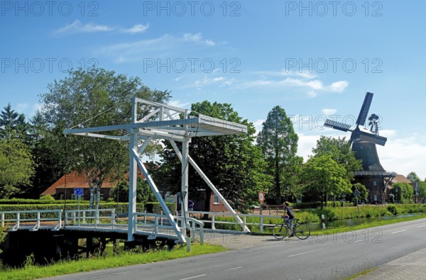 East Frisian bascule bridge, cyclist, gallery bridge, Großefehn, East Frisia, Germany, Lower Saxony, Germany