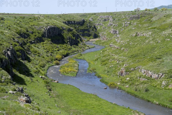 A river meanders through a green gorge under a blue sky, Achuryan River, Akhuryan, near Jradzor, Shirak Province, Armenia
