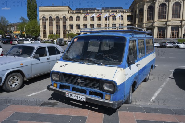 A blue van parked in front of a classic building under a clear sky, car RAF-2203 Latvija, nicknamed Rafik, in front of the town hall, Gyumri, Gyumri, Shirak province, Armenia
