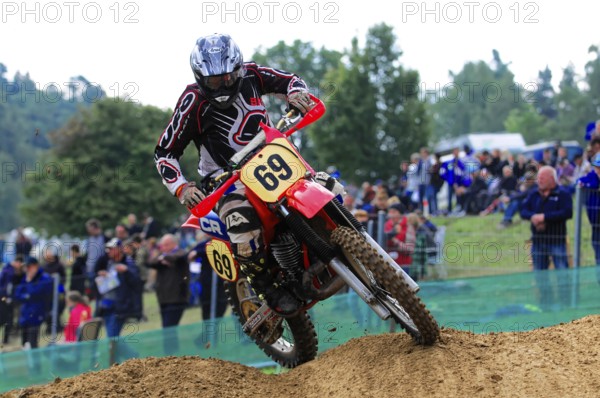 Motocross, Rudersberg, Baden-Württemberg, Germany, Europe, A motocross rider navigates a sandy bend while spectators watch the race, Rudersberg Motocross