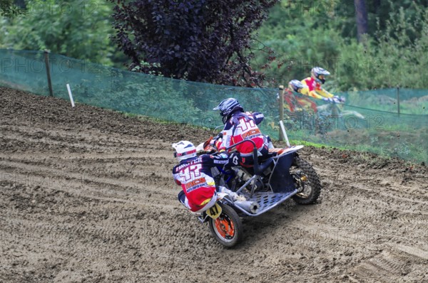 Motocross, Rudersberg, Baden-Württemberg, Germany, Europe, Two riders on a motorbike with sidecar drive through in an off-road race, Rudersberg motocross
