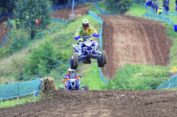 Motocross, Rudersberg, Baden-Württemberg, Germany, Europe, A quad bike rider jumps into the air on a motocross track, followed by another rider, Rudersberg motocross