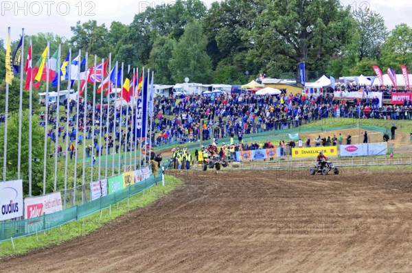 Motocross, Rudersberg, Baden-Württemberg, Germany, Europe, A race track with numerous spectators and international flags, surrounded by green trees, Rudersberg Motocross