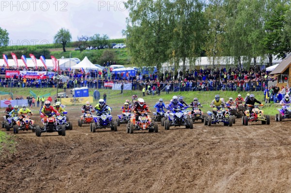 Motocross, Rudersberg, Baden-Württemberg, Germany, Europe, Several quad bikers start a race, watched by spectators behind a row of tents, Rudersberg motocross