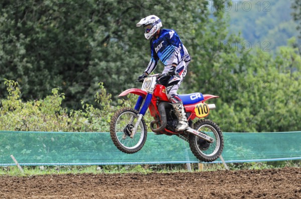 Motocross, Rudersberg, Baden-Württemberg, Germany, Europe, A rider dressed in blue jumps with his motorbike during a motocross race, Rudersberg Motocross