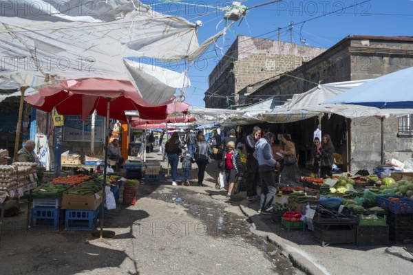 Lively outdoor market with many stalls and people under awnings, Gyumri, Giumri, Gyumri, Shirak province, Armenia