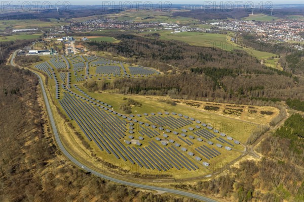 Aerial view, solar plant on the former Prinz-Eugen barracks, with industrial and commercial park, asphalt mixing plant, Asphaltwerke Waldeck GmbH & Co. KG, Bad Arolsen, district of Waldeck-Frankenberg, Hesse, Germany, DEU, Europe, birds-eyes view, aerial view, aerial photography, aerial photography, overview, bird's eye view, solar energy, photovoltaic plant, large-scale plant, solar field, conversion