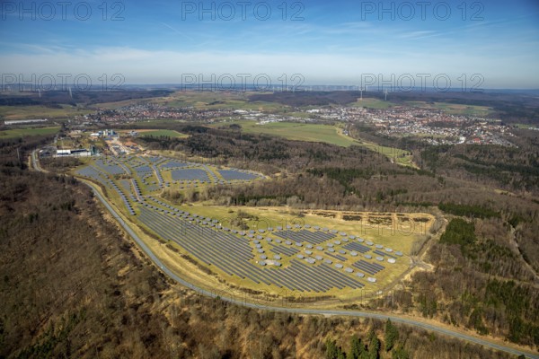 Aerial view, solar plant on the former Prinz-Eugen barracks, with industrial and commercial park, asphalt mixing plant, Asphaltwerke Waldeck GmbH & Co. KG, Bad Arolsen, district of Waldeck-Frankenberg, Hesse, Germany, DEU, Europe, birds-eyes view, aerial view, aerial photography, aerial photography, overview, bird's eye view, solar energy, photovoltaic plant, large-scale plant, solar field, conversion
