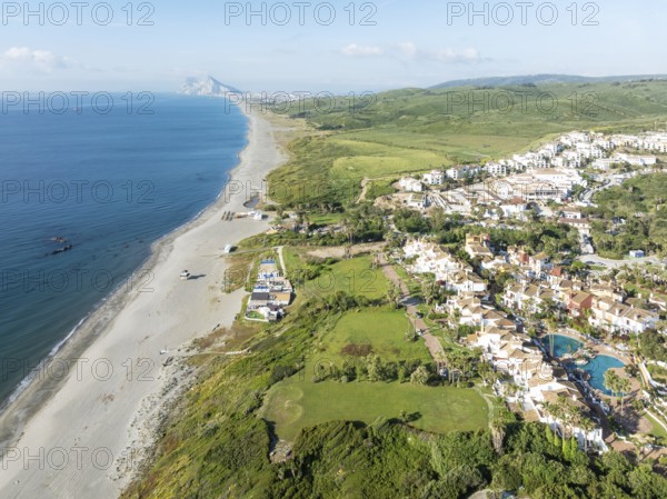The La Alcaidesa urbanization at the Mediterranean Sea with the Rock of Gibraltar (British) in the distance. Aerial view. Drone shot. Cádiz province, Andalusia, Spain