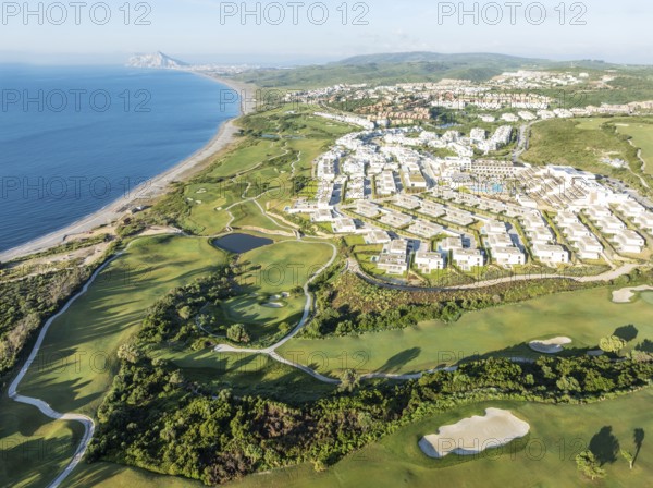 The La Hacienda Links Golf Resort at the Mediterranean Sea with the Rock of Gibraltar (British) in the distance. Prominent the Fairmont La Hacienda hotel. Aerial view. Drone shot. Cádiz province, Andalusia, Spain