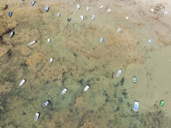 Fishing boats at low tide in the town of Cádiz. Aerial view. Drone shot. Cádiz province, Andalusia, Spain