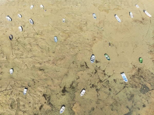 Fishing boats at low tide in the town of Cádiz. Aerial view. Drone shot. Cádiz province, Andalusia, Spain