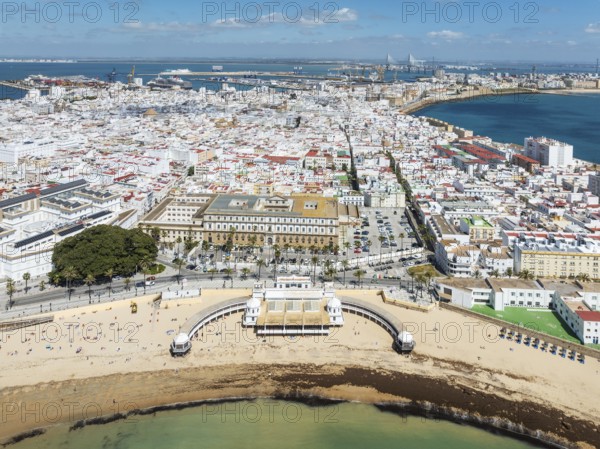 The town of Cádiz with the old quarter in the foreground. Prominent the Caleta beach and the old Balneario de la Palma. Aerial view. Drone shot. Cádiz province, Andalusia, Spain