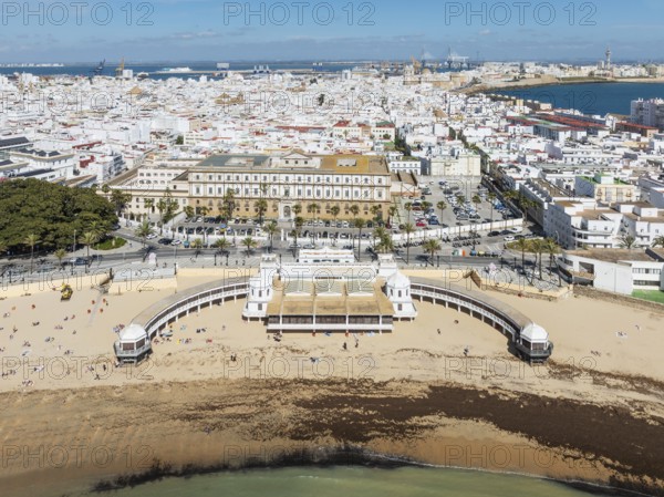 The town of Cádiz with the old quarter in the foreground. Prominent the Caleta beach and the old Balneario de la Palma. Aerial view. Drone shot. Cádiz province, Andalusia, Spain