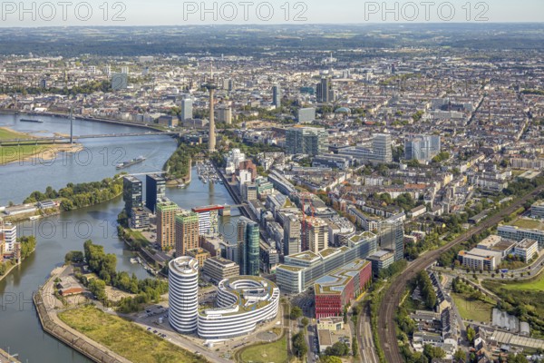 Aerial view, Media Harbour at the river Rhine, Rhine Tower and Rheinknie Bridge, in front construction site with construction crane and new Uniq Towers between Kaistraße and Zollhof, view over Düsseldorf City with Old Town, harbour, Düsseldorf, Ruhr area, North Rhine-Westphalia, Germany, Old Town, construction work, construction area, construction site, building plots, construction, construction project, construction site, bridge, DE, Europe, commercial enterprise, commercial space, commercial area, commercial property, commercial location, commercial use, industrial area, industrial location, aerial view, aerial photography, aerial photography, new building, tower, overview, bird's eye view, birds-eyes view, overview