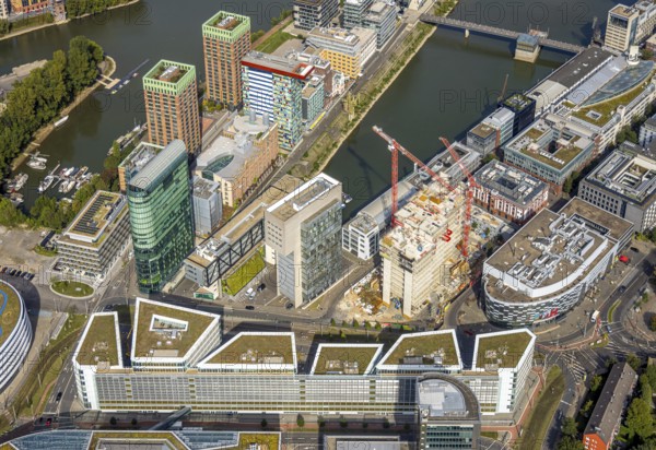 Aerial view, Media harbour on the river Rhine, construction site with construction crane and new Uniq Towers between Kaistraße and Zollhof, harbour, Düsseldorf, Ruhr area, North Rhine-Westphalia, Germany, construction work, construction area, construction site, building plots, construction crane, construction project, construction site, DE, Europe, commercial enterprise, commercial space, commercial area, commercial property, commercial site, commercial use, industrial area, industrial site, aerial view, aerial photography, aerial photography, media centre, new building, overview, bird's-eye view, overview