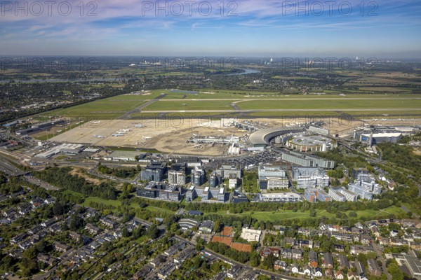 Aerial view, DUS Airport Düsseldorf with reception building, runway and landing strip, commercial area DUS Airport-City, distant view and blue sky with clouds, Lohausen, Düsseldorf, Ruhr area, North Rhine-Westphalia, Germany, terminal building, DE, reception building, Europe, flight mission, airport, aircraft noise, airfield, runway, aerial view, aerial photography, aerial photography, runway, overview, bird's-eye view, overview