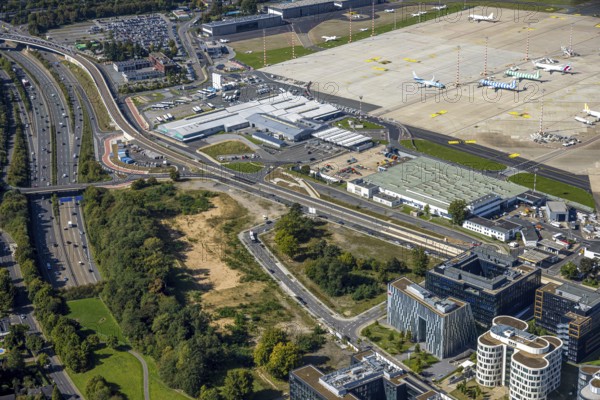 Aerial view, DUS Airport Düsseldorf apron, commercial area DUS Airport-City airport road and motorway A44 connection, brownfield, Lohausen, Düsseldorf, Ruhr area, North Rhine-Westphalia, Germany, terminal building, DE, reception building, Europe, flight emission, airport, aircraft noise, airfield, runway, aerial photograph, aerial photography, aerial photography, runway, overview, bird's-eye view, birds-eyes view, overview