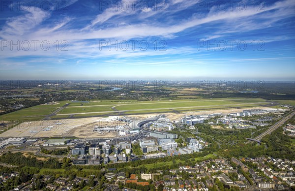 Aerial view, DUS Airport Düsseldorf with reception building, runway and landing strip, commercial area DUS Airport-City, distant view and blue sky with clouds, Lohausen, Düsseldorf, Ruhr area, North Rhine-Westphalia, Germany, terminal building, DE, reception building, Europe, flight mission, airport, aircraft noise, airfield, runway, aerial view, aerial photography, aerial photography, runway, overview, bird's-eye view, overview