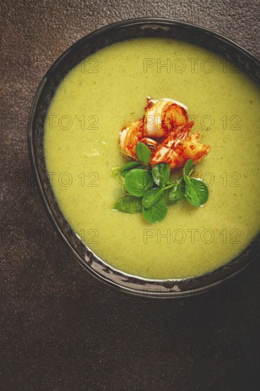 Pea cream soup, with shrimp, green soup, homemade, top view, no people