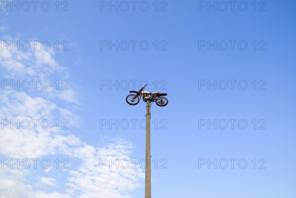 Motorcycle on the pedestal. A light motorbike on a pole, put up as a dummy or a monument. Krasnodar, Russia