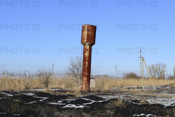 The old rusty water tower tilted. Atyrau, Kazakhstan
