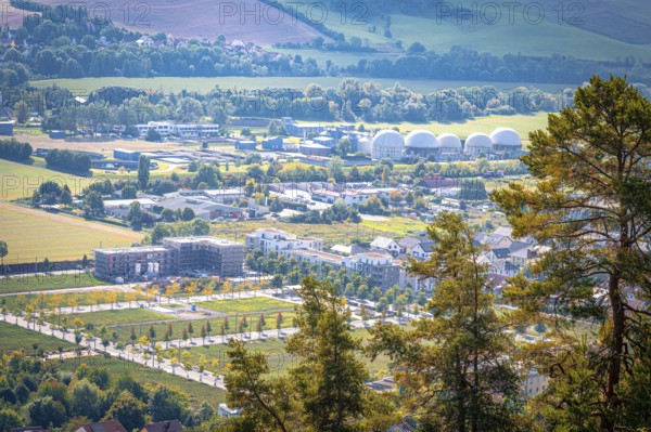 View of the residential area at Ölste with industrial buildings and trees in the foreground, Jena, Thuringia, Germany