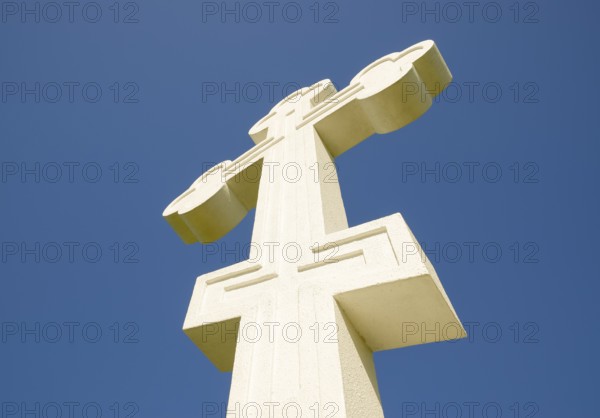 White orthodox christian cross on blue sky background. Krasnodar, Russia