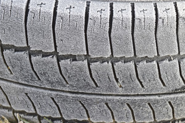 Hoarfrost on a rubber tire wheel. Morning frost
