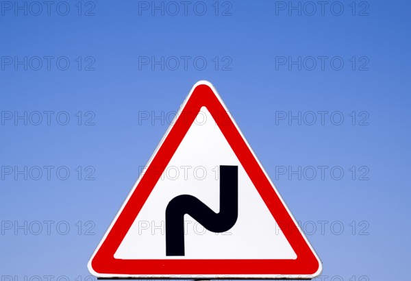 Road sign dangerous turn. Warning a sign. Krasnodar, Russia