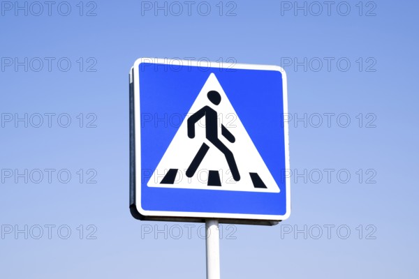 A pedestrian crossing sign. Sign on a blue sky background. Krasnodar, Russia