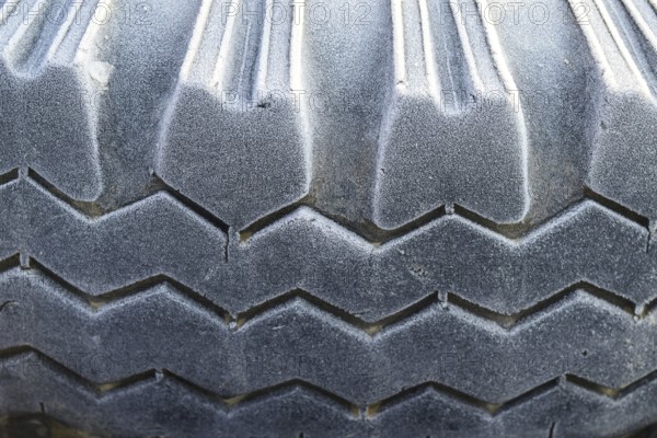 Hoarfrost on a rubber tire wheel. Krasnodar, Russia