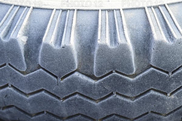Hoarfrost on a rubber tire wheel. Krasnodar, Russia