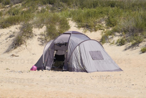 Tourist tent on the sand. Parking of tourists on the sandy beach. Golubitskaya, Russia