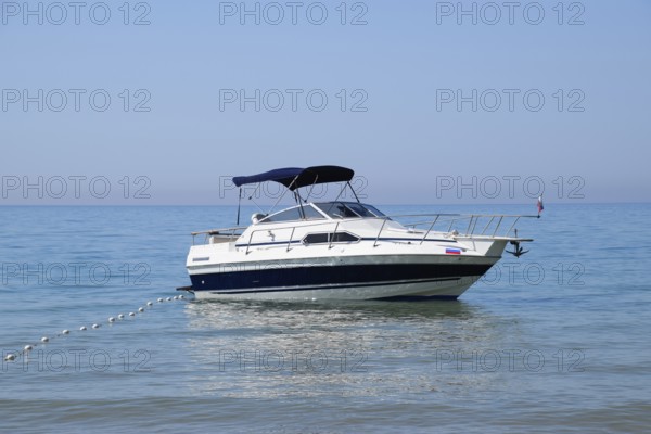 A small boat yacht in the sea near the shore. Golubitskaya, Russia