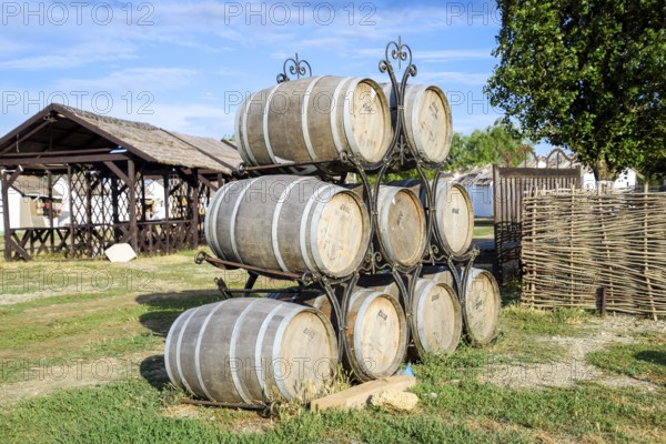 Stacked wine barrels. Decoration of the barrels in the village Ataman. Taman, Krasnodar Krai, Russia