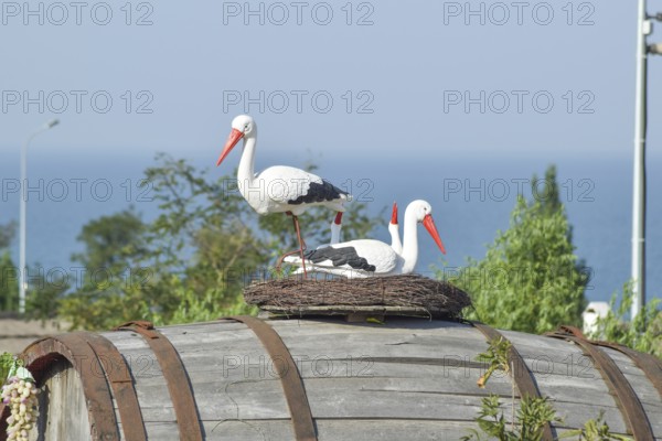 Toy nest of a stork with birds on it. Taman, Krasnodar Krai, Russia