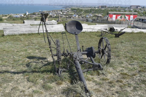 The exhibit of the old plow on the grass. Taman, Krasnodar Krai, Russia
