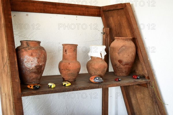Shelves with standing on their utensils of porcelain and earthenware. Taman, Krasnodar Krai, Russia