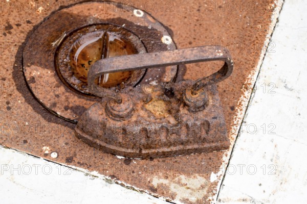 An ancient iron iron on the stove. Taman, Krasnodar Krai, Russia