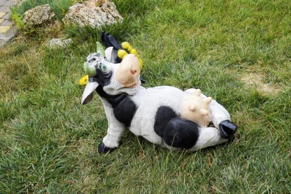 Toy cow lying upside udder. Taman, Krasnodar Krai, Russia