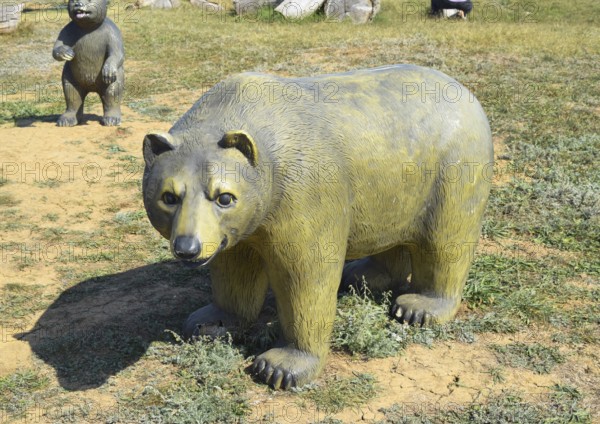 Mannequin dummy bear on the lawn. Taman, Krasnodar Krai, Russia