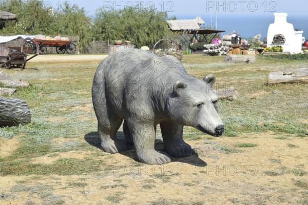 Mannequin dummy bear on the lawn. Taman, Krasnodar Krai, Russia