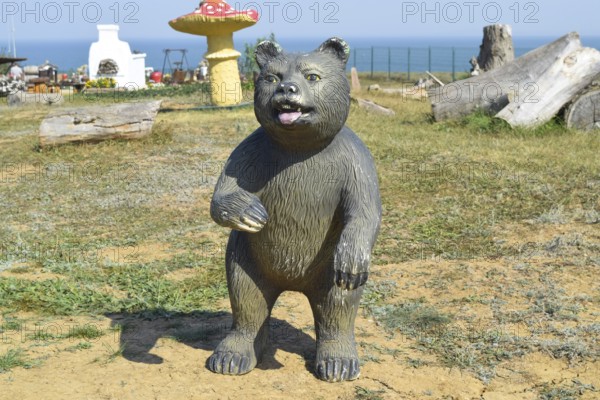 Mannequin dummy bear on the lawn. Taman, Krasnodar Krai, Russia