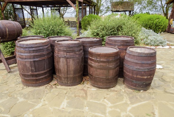 Stacked wine barrels. Decoration of the barrels in the village Ataman. Taman, Krasnodar Krai, Russia
