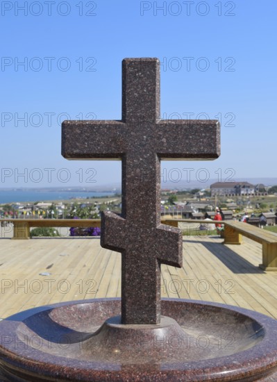 Orthodox cross made of granite near the chapel. Taman, Krasnodar Krai, Russia