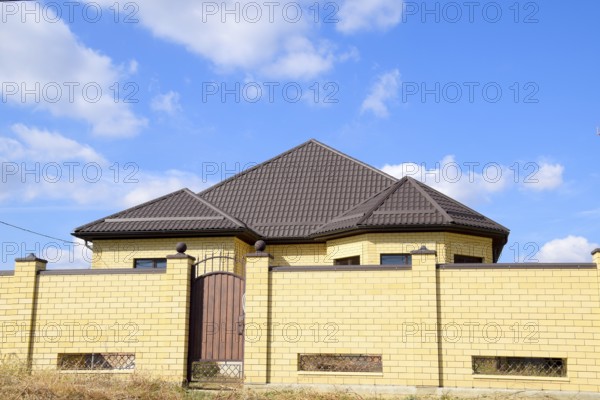 Decorative metal on the roof of a brick house. Atyrau, Kazakhstan