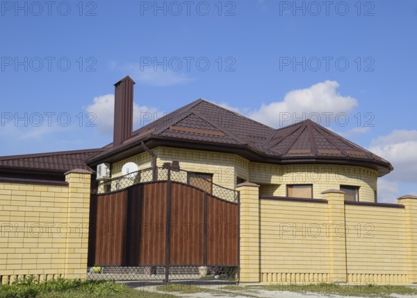 Decorative metal on the roof of a brick house. Atyrau, Kazakhstan