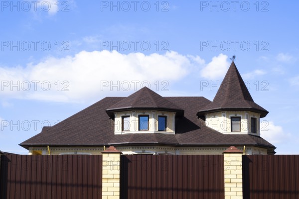 Decorative metal on the roof of a brick house. Atyrau, Kazakhstan